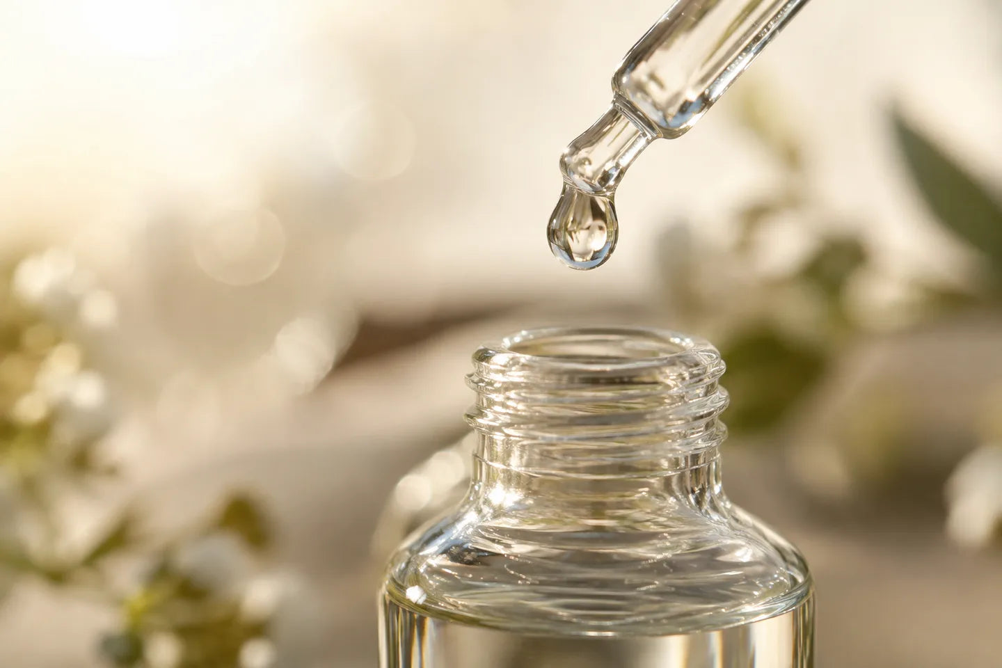 Illustrative Rohstoffdarstellung: Wassertropfen an einer Glaspipette